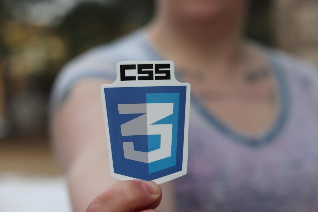 Woman Holding Up a CSS3 Sticker