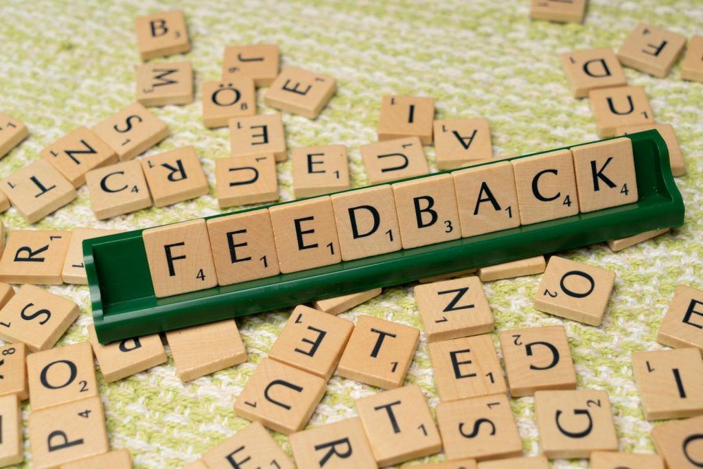 The word feedback is spelled out with scrabble tiles