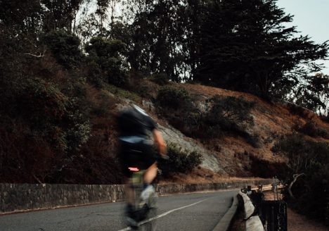 man riding bicycle on road