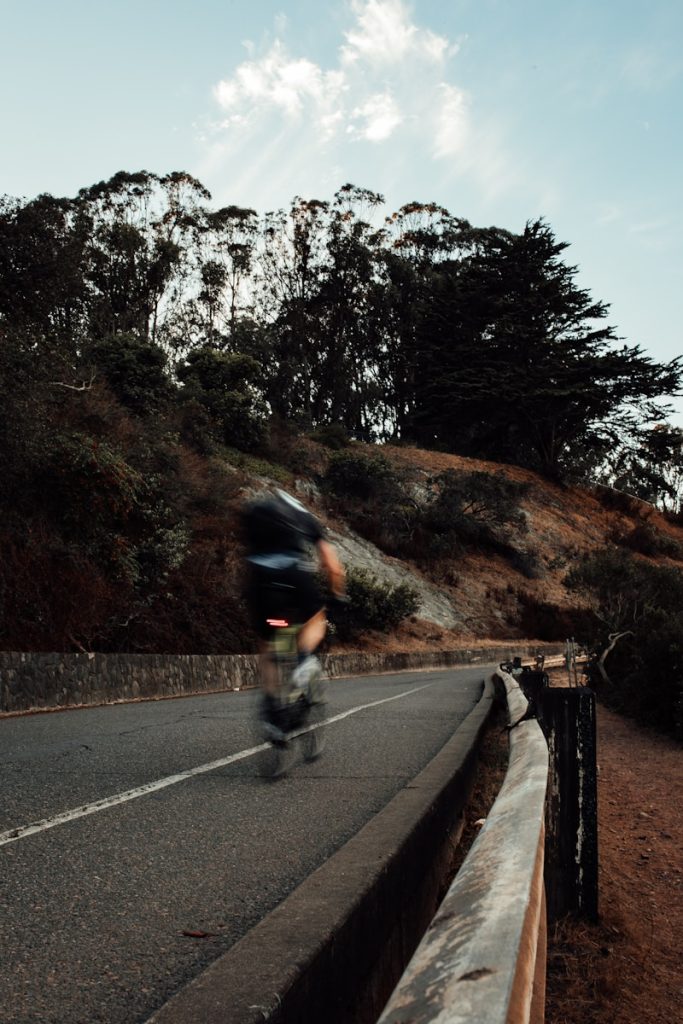 man riding bicycle on road