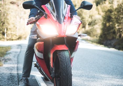 Person Riding Red Sports Bike