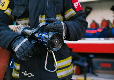 Close-up of a Firefighter Holding a Firehose