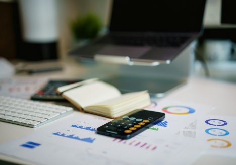 a remote control sitting on top of a table next to a book