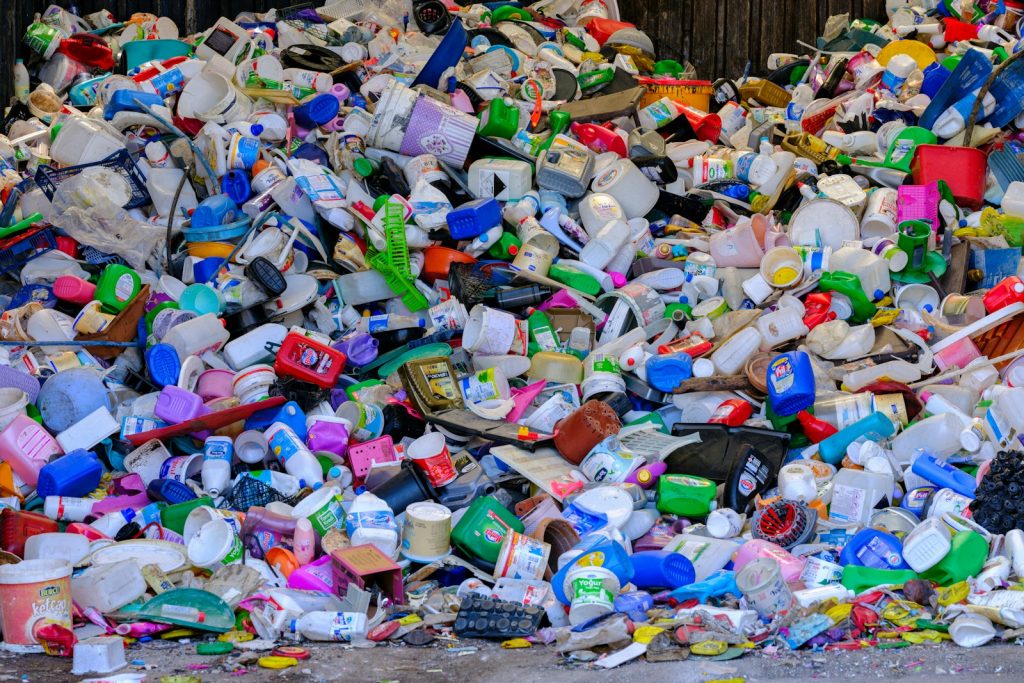 A pile of plastic bottles sitting on top of a street