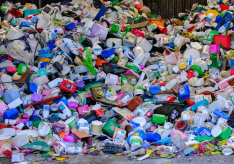 A pile of plastic bottles sitting on top of a street