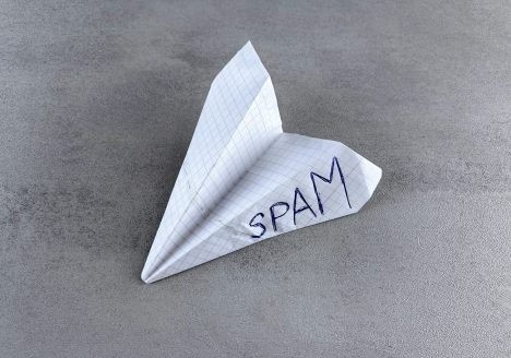 a paper airplane with the word spam written on it